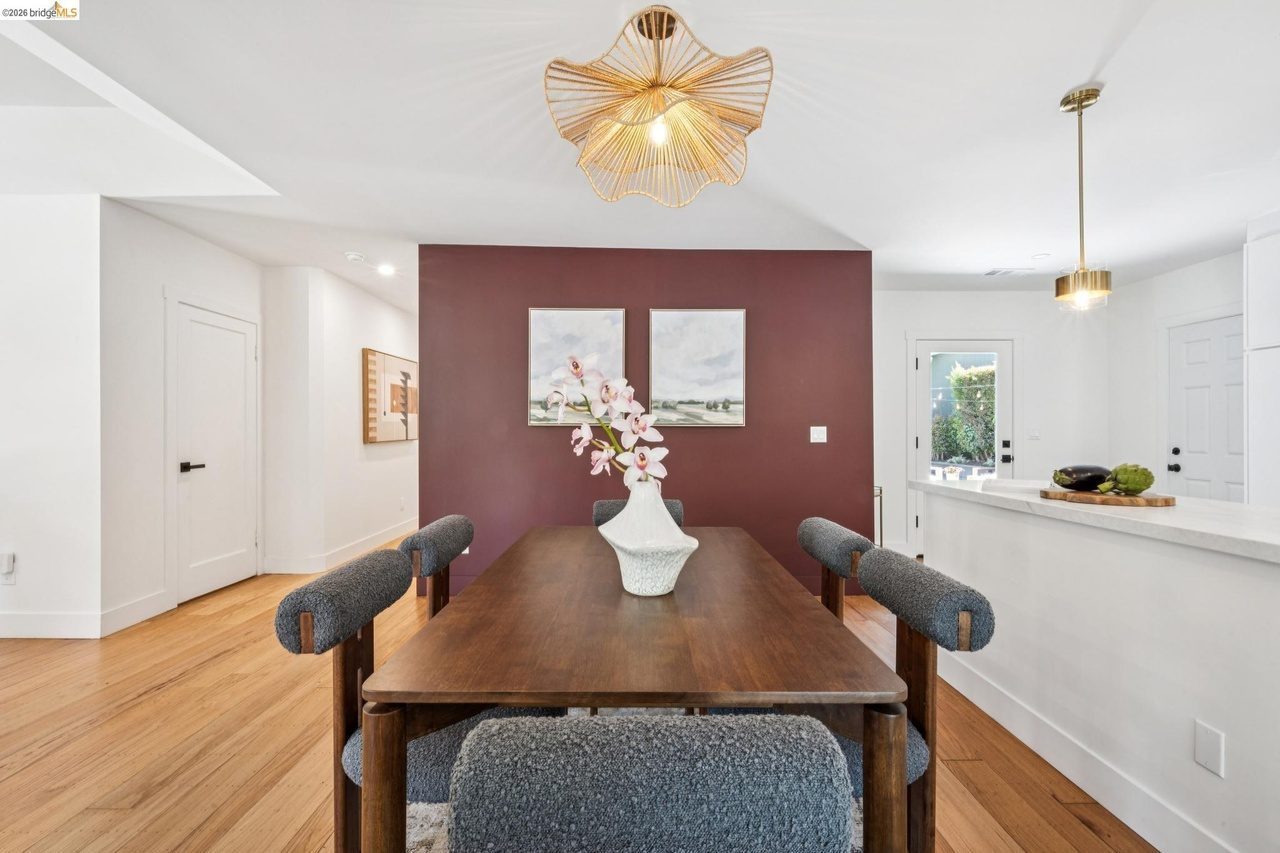Dining area with maroon accent wall and new modern lighting fixture